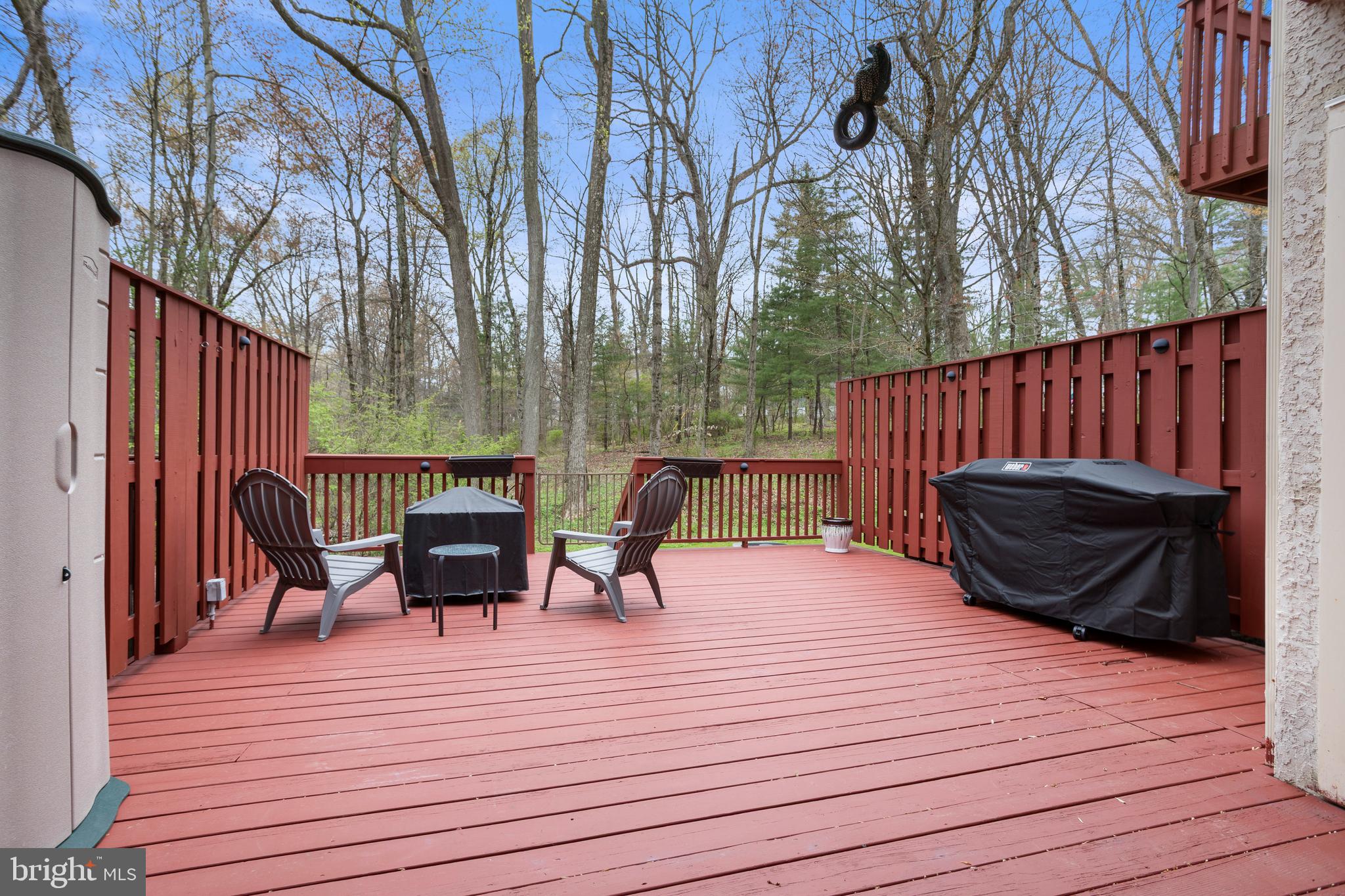326 Westbriar Drive Media, PA 19063 - Photo 27 of 29 a view of a roof deck with table and chairs a barbeque with wooden floor and fence