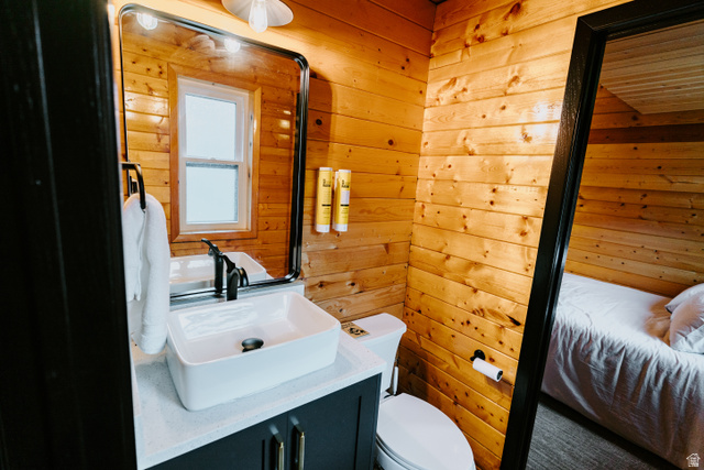 1413 Basel Drive Midway, UT 84049 - Photo 66 of 137 Bathroom with wooden walls, vanity, and ensuite bathroom