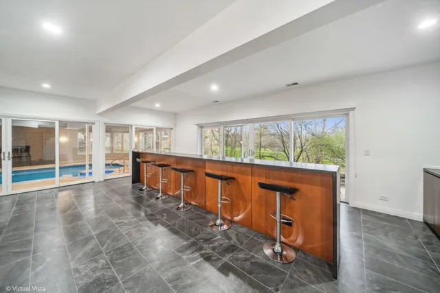 a kitchen with stainless steel appliances granite countertop a lot of cabinets