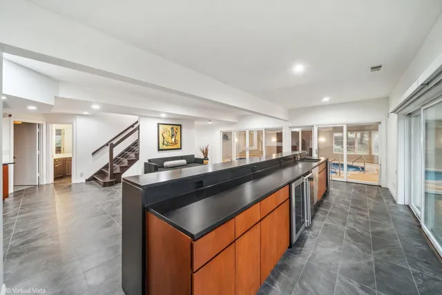 a view of a livingroom with furniture a fireplace and windows