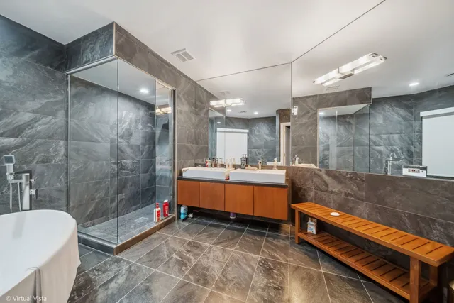 a spacious bathroom with a sink mirror and a bathtub