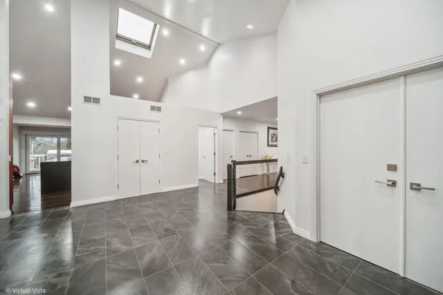 a living room with furniture large window and wooden floor