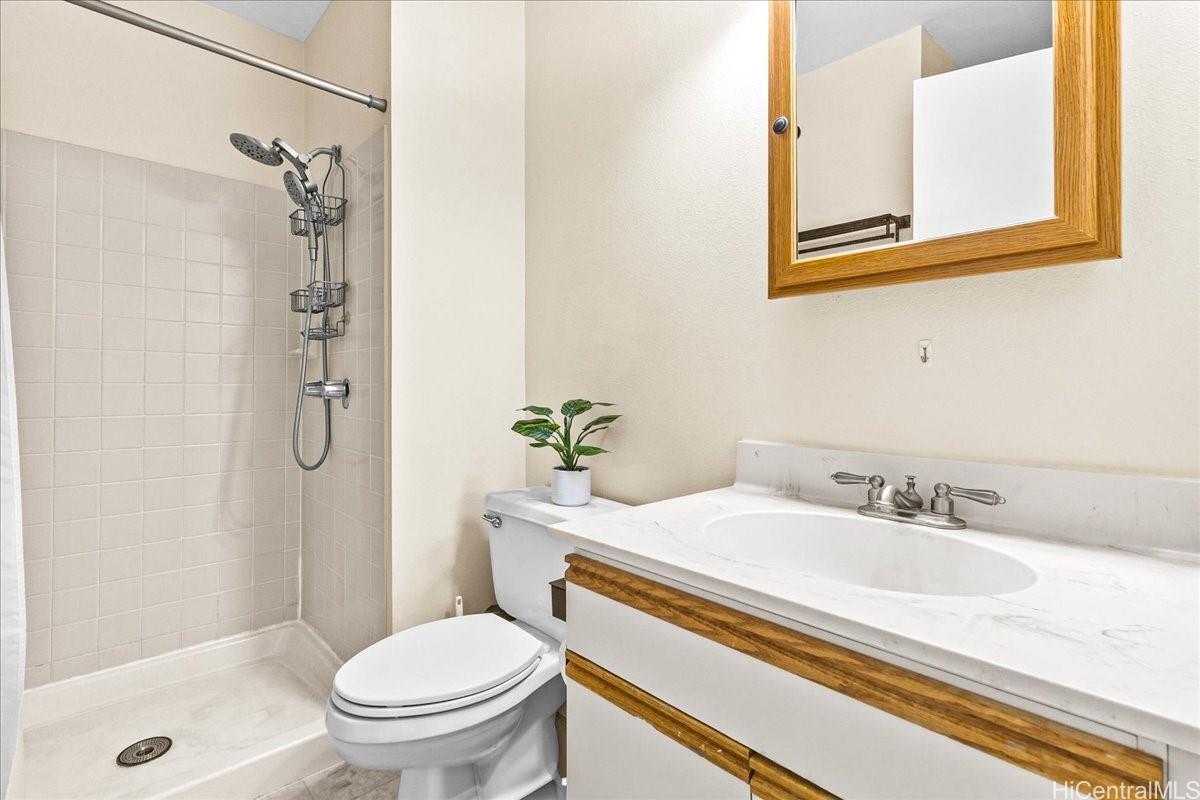 92-1019 Alaa Street, Unit 16203 Kapolei, HI 96707 - Photo 16 of 25 a bathroom with a sink toilet and shower