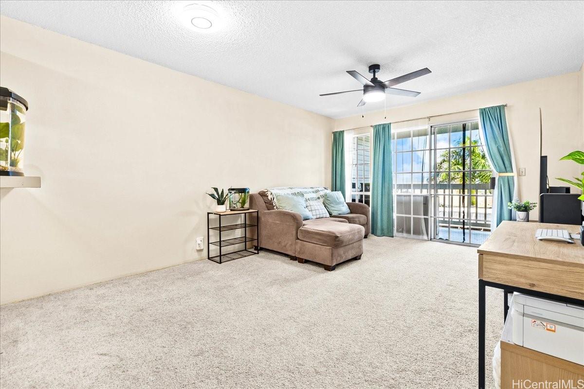 92-1019 Alaa Street, Unit 16203 Kapolei, HI 96707 - Photo 21 of 25 a spacious bedroom with a bed a large window with table and chairs