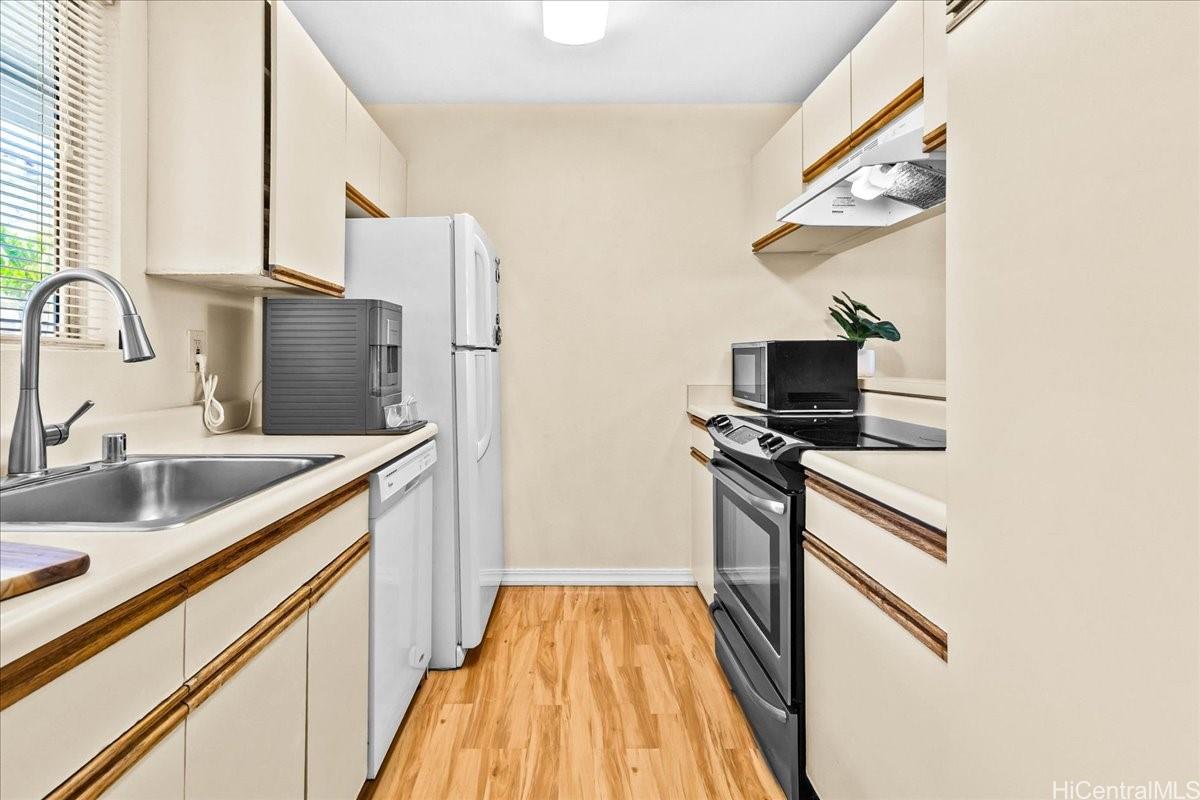 92-1019 Alaa Street, Unit 16203 Kapolei, HI 96707 - Photo 5 of 25 a kitchen with stainless steel appliances granite countertop a sink and a stove