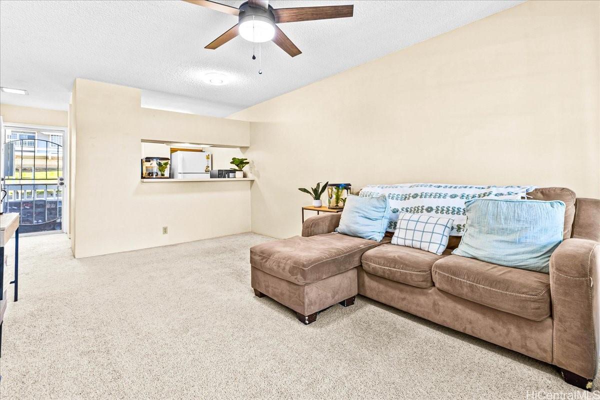 92-1019 Alaa Street, Unit 16203 Kapolei, HI 96707 - Photo 8 of 25 a living room with furniture and a couch