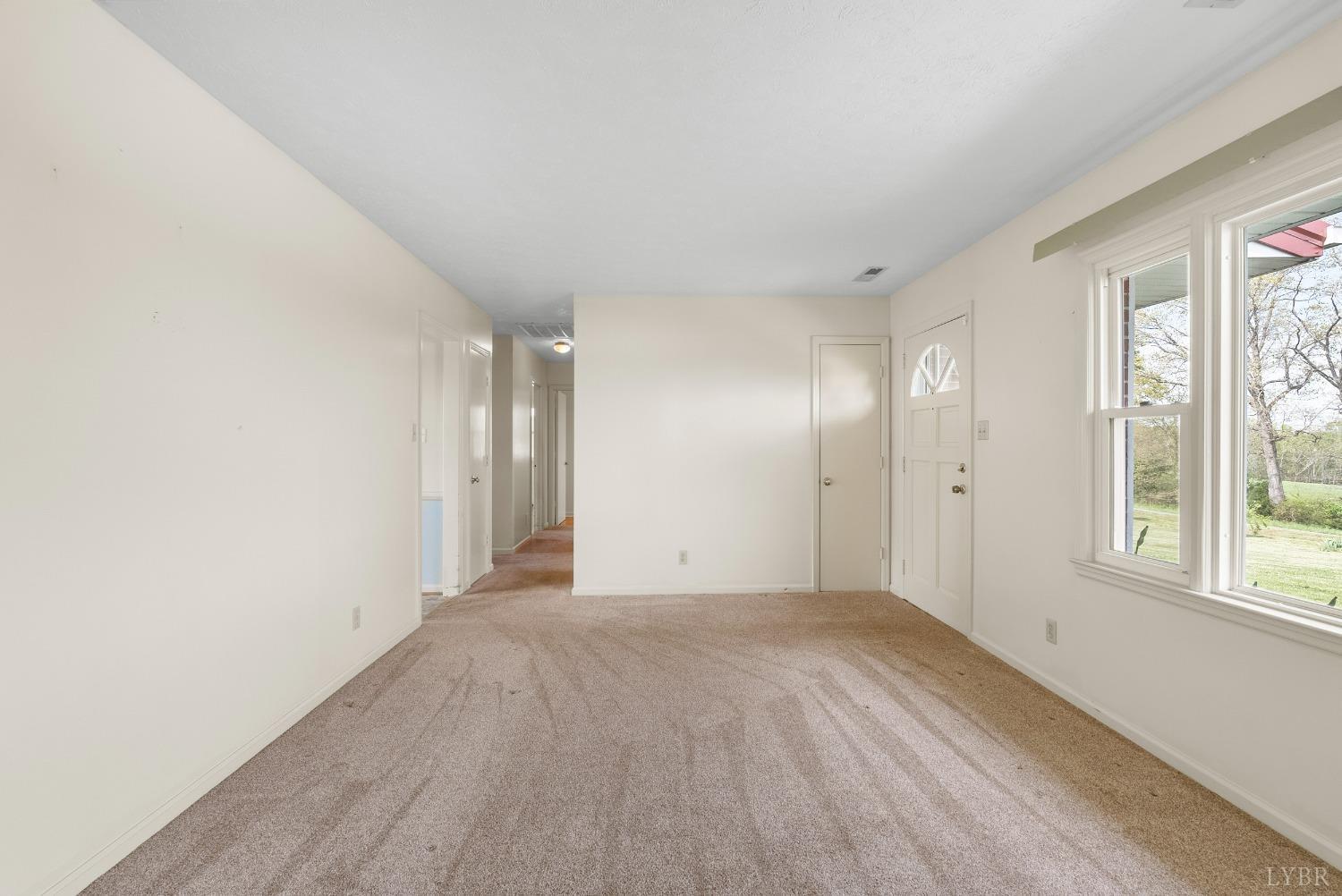 983 East Ferry Road Gladys, VA 24554 - Photo 6 of 62 a view of an empty room with wooden floor and a window