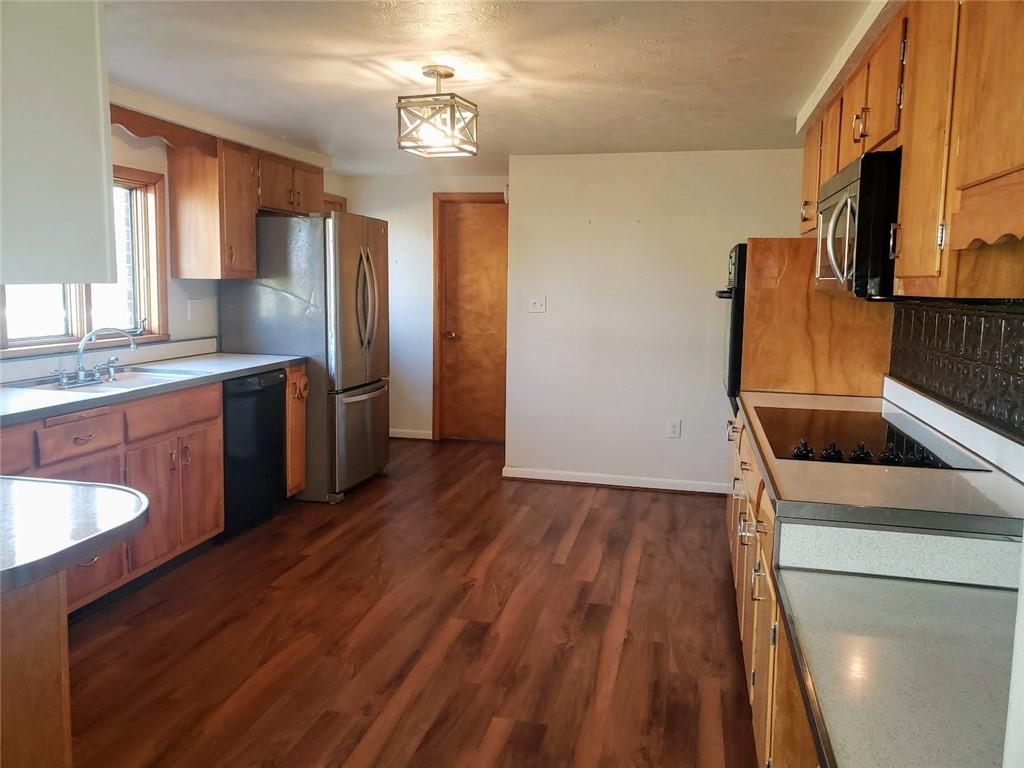 161 North Benbrook Road Butler, PA 16001 - Photo 9 of 25 a kitchen with stainless steel appliances granite countertop a sink a stove a refrigerator cabinets and wooden floor