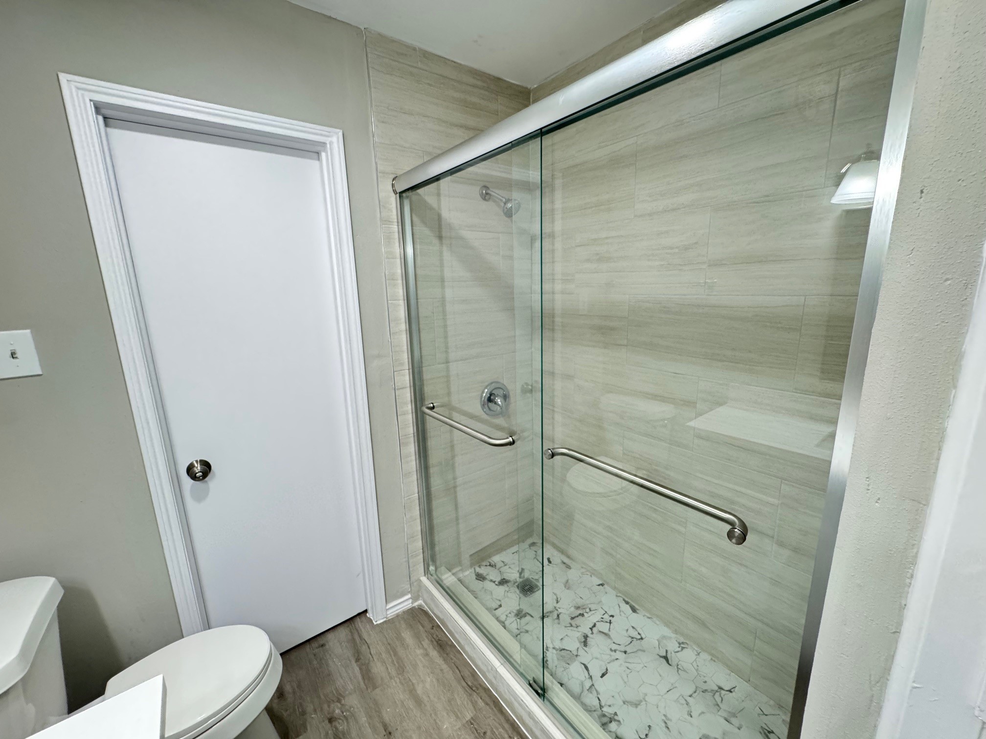 9114 Kempwood Drive, Unit 9114 Houston, TX 77080 - Photo 11 of 16 a bathroom with a shower and a toilet
