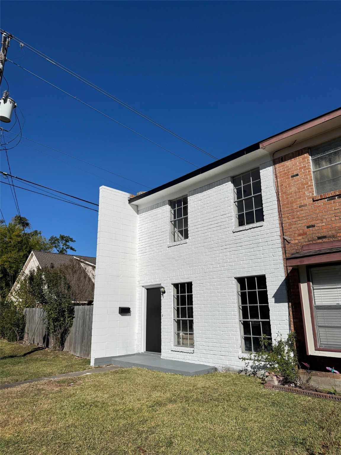 9114 Kempwood Drive, Unit 9114 Houston, TX 77080 - Photo 2 of 16 a front view of a house with a yard