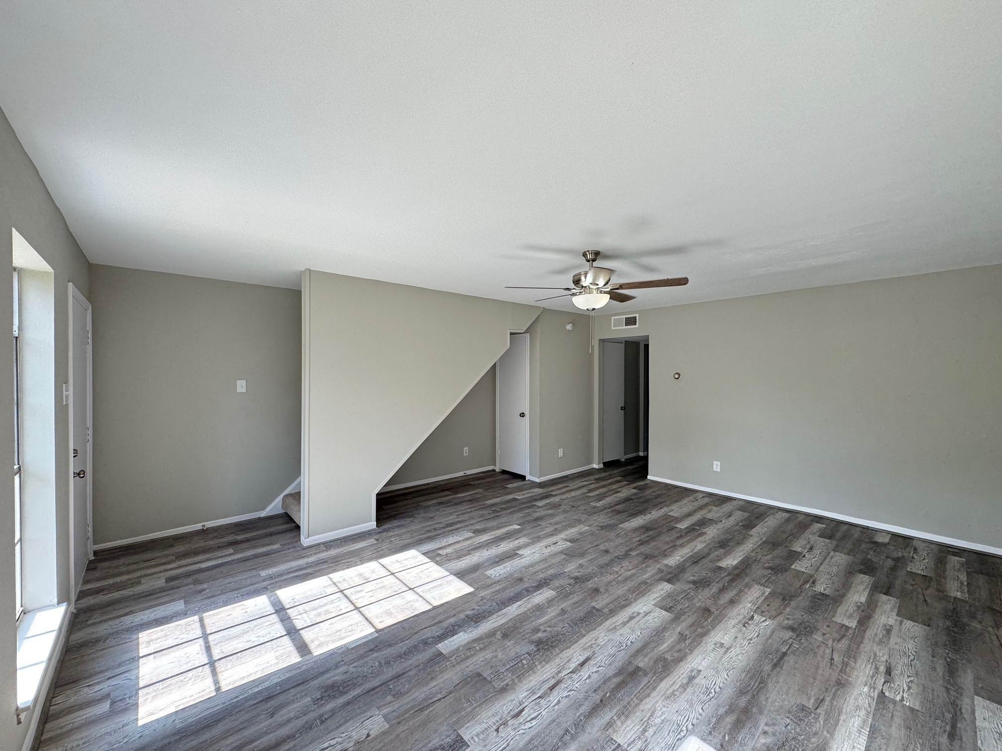 9114 Kempwood Drive, Unit 9114 Houston, TX 77080 - Photo 5 of 16 wooden floor in an empty room with a window