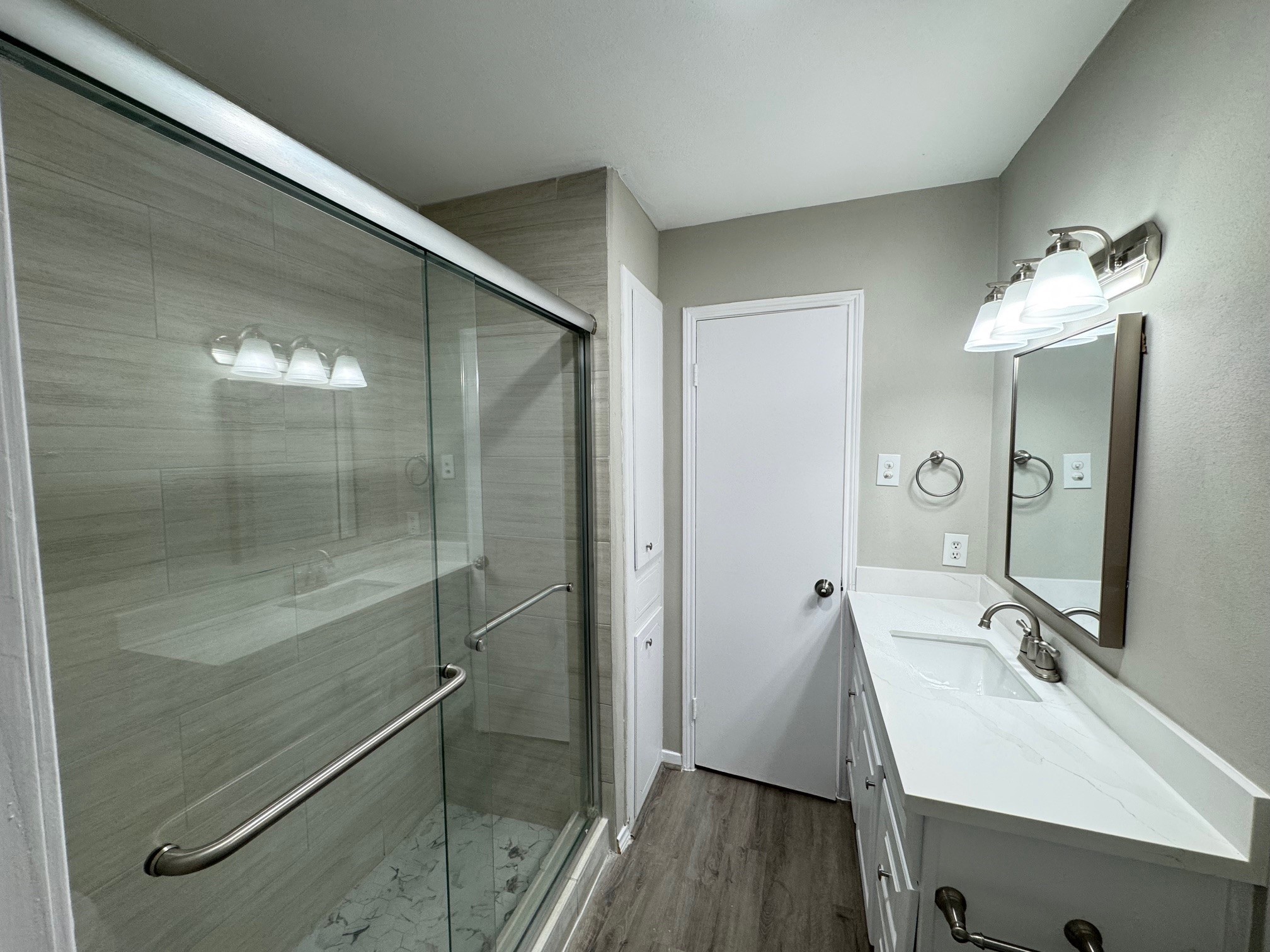 9114 Kempwood Drive, Unit 9114 Houston, TX 77080 - Photo 10 of 16 a bathroom with a sink mirror and shower