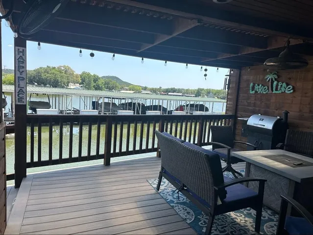 a view of a balcony with wooden floor and outdoor seating