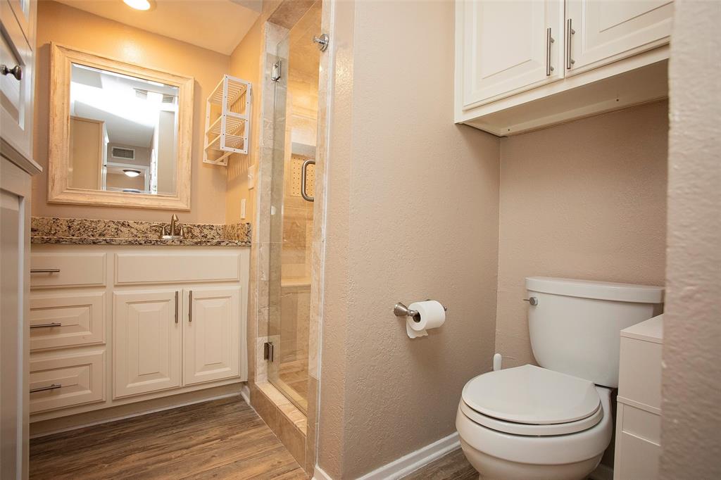1361 Willow Beach Road, Unit A5 Graford, TX 76449 - Photo 11 of 17 a bathroom with a granite countertop toilet sink and a mirror