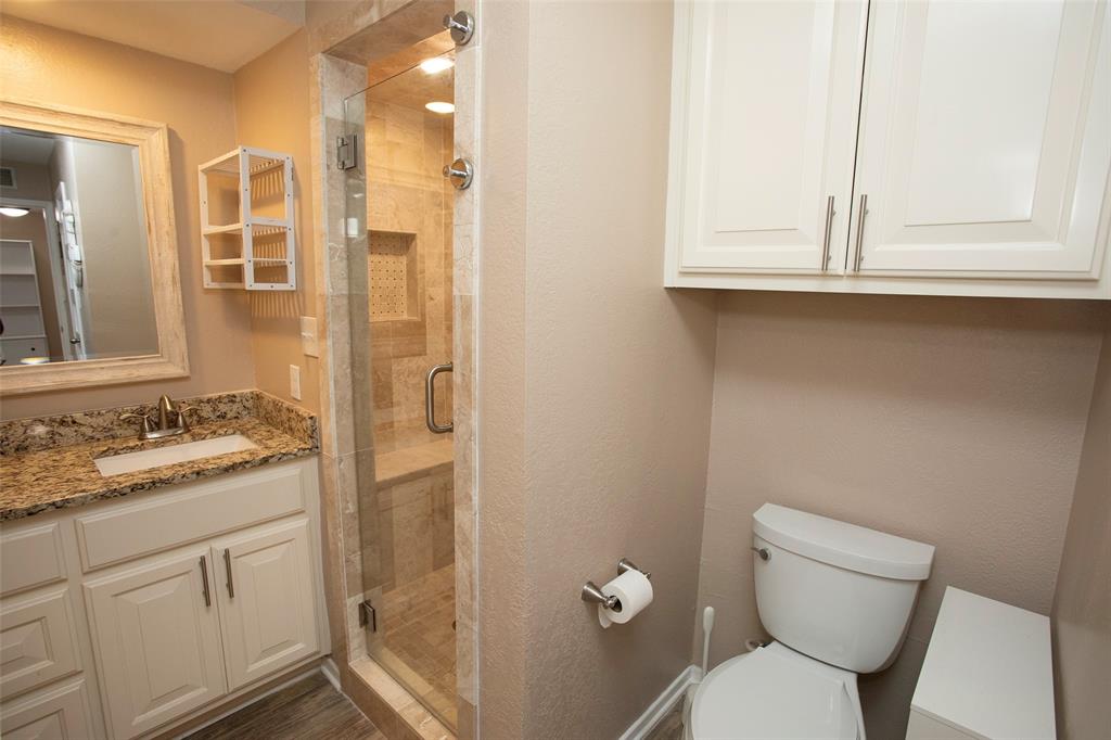1361 Willow Beach Road, Unit A5 Graford, TX 76449 - Photo 12 of 17 a bathroom with a granite countertop toilet sink and mirror
