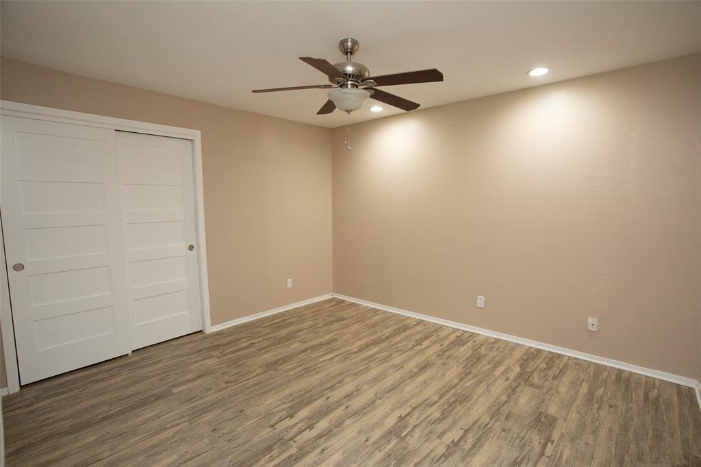 1361 Willow Beach Road, Unit A5 Graford, TX 76449 - Photo 15 of 17 an empty room with wooden floor and windows