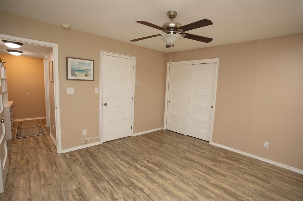 1361 Willow Beach Road, Unit A5 Graford, TX 76449 - Photo 16 of 17 a view of a big room with wooden floor and a ceiling fan
