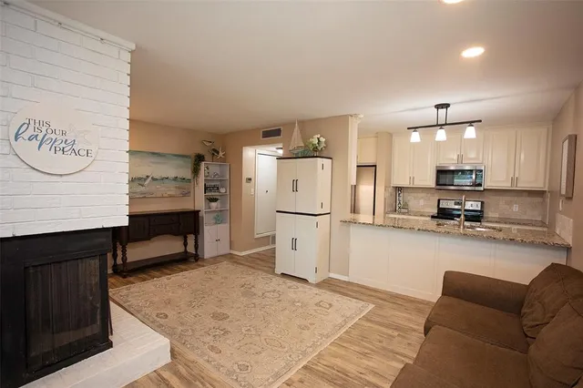 a view of kitchen with furniture and refrigerator