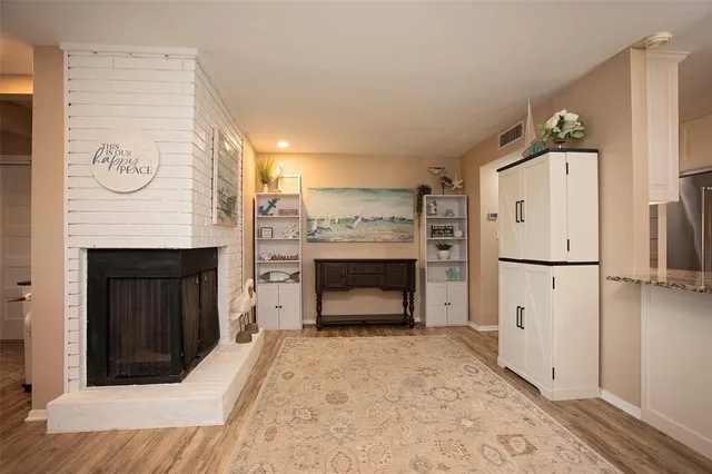 a room with a refrigerator and a fireplace