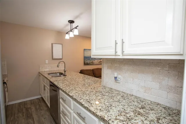 a kitchen with a sink and cabinets