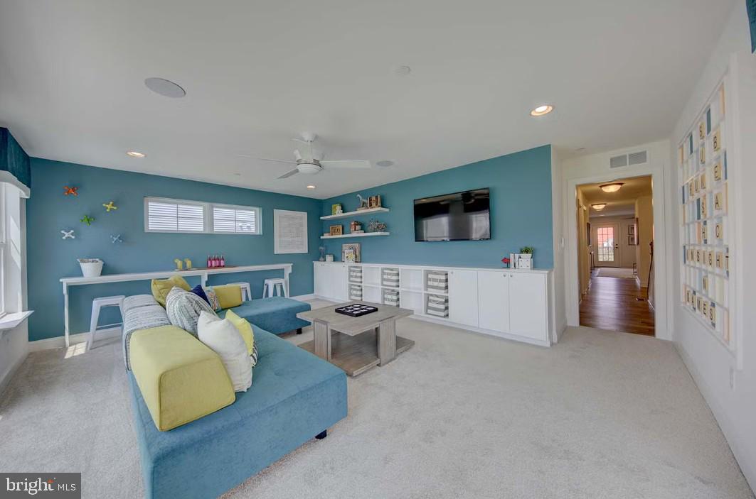 401 Bering Road Ocean City, MD 21842 - Photo 12 of 74 a living room with furniture and a flat screen tv
