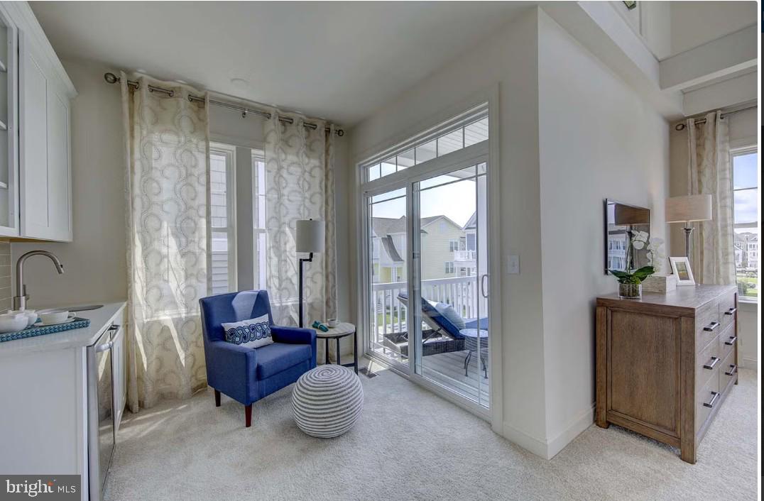 401 Bering Road Ocean City, MD 21842 - Photo 32 of 74 a living room with furniture and a floor to ceiling window