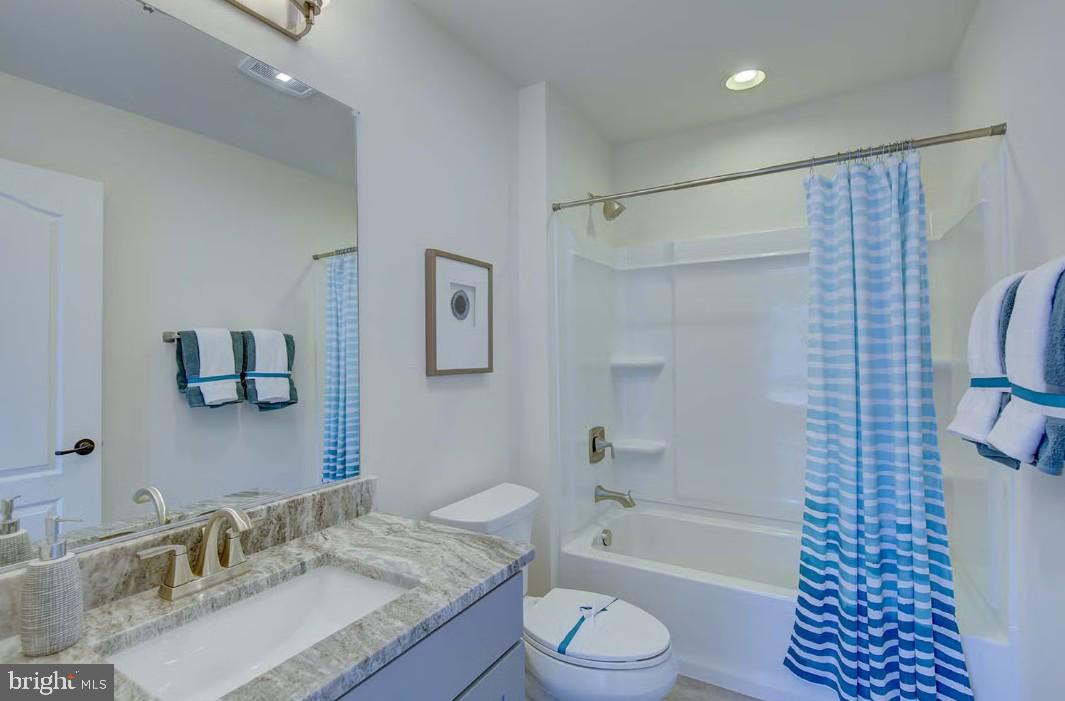 401 Bering Road Ocean City, MD 21842 - Photo 43 of 74 a bathroom with a granite countertop sink toilet a shower and a mirror