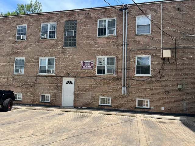 a front view of a building with parking space