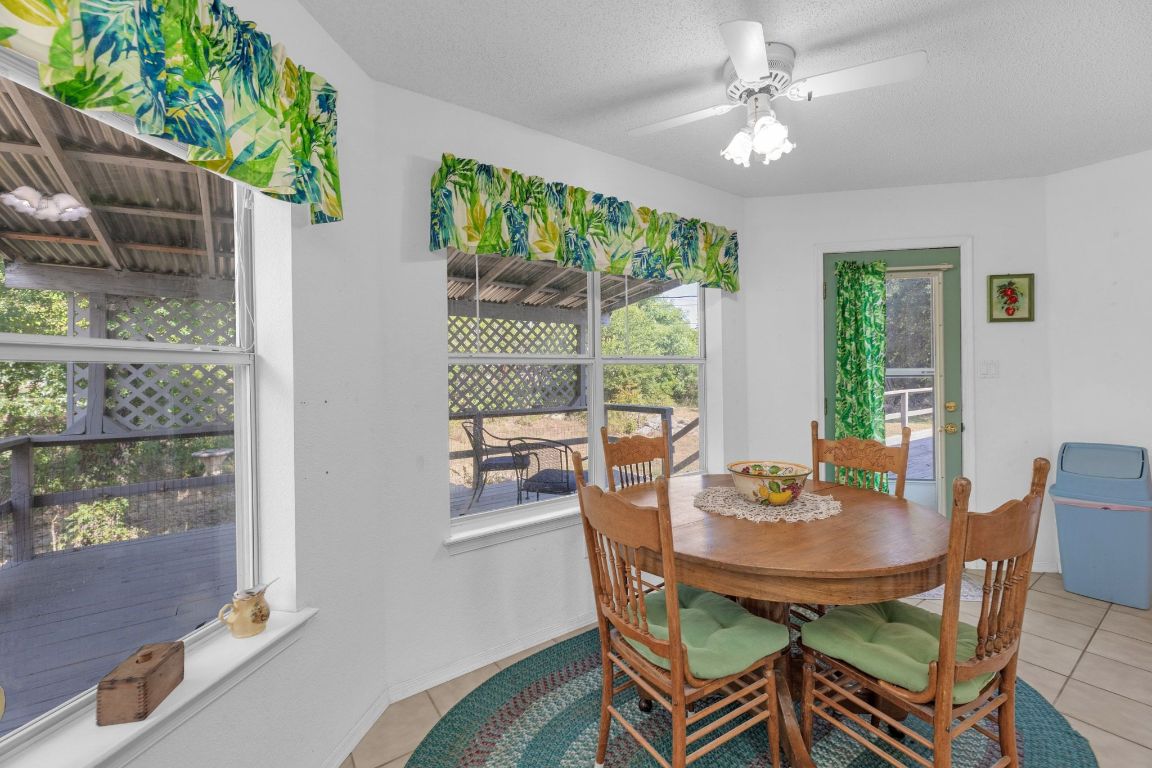 2105 Sam Bass Road Round Rock, TX 78681 - Photo 14 of 40 a view of a dining room with furniture a rug and wooden floor