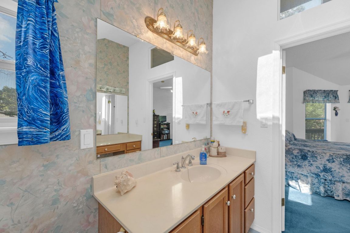 2105 Sam Bass Road Round Rock, TX 78681 - Photo 23 of 40 a en suite bathroom with a sink and a mirror