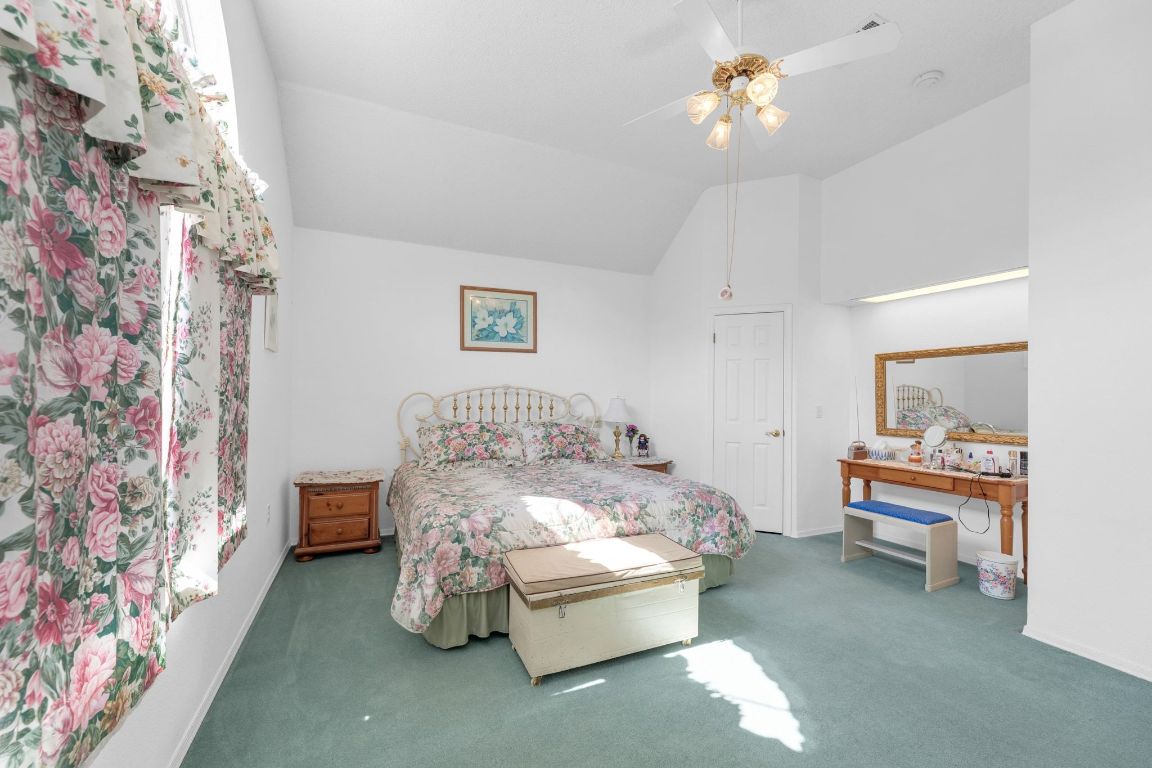 2105 Sam Bass Road Round Rock, TX 78681 - Photo 25 of 40 a bedroom with a bed and a chandelier