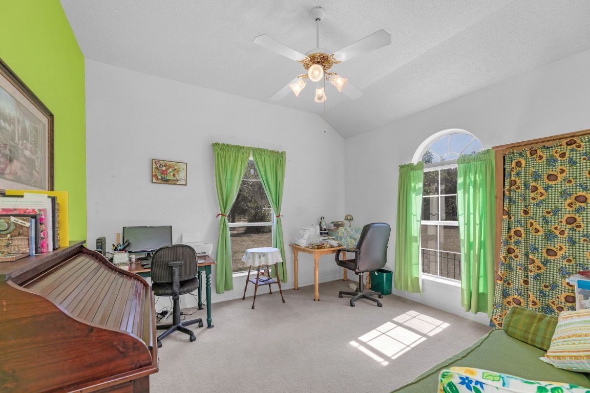 2105 Sam Bass Road Round Rock, TX 78681 - Photo 27 of 40 a living room with furniture a chandelier and a window