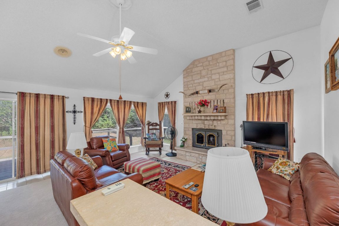 2105 Sam Bass Road Round Rock, TX 78681 - Photo 8 of 40 a living room with fireplace furniture and a flat screen tv