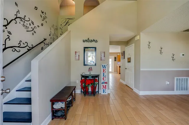 a view of a hallway with wooden floor and entryway