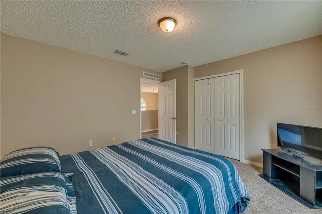 a bedroom with a bed and a television