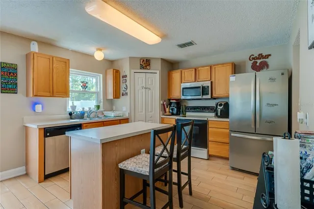 a kitchen with stainless steel appliances a sink and a refrigerator