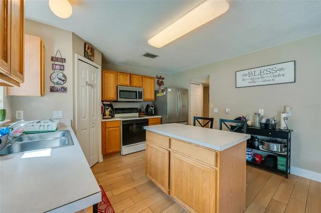 a kitchen that has a sink and a stove in it