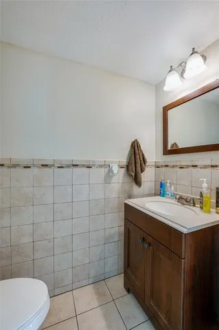 a bathroom with a sink vanity and toilet