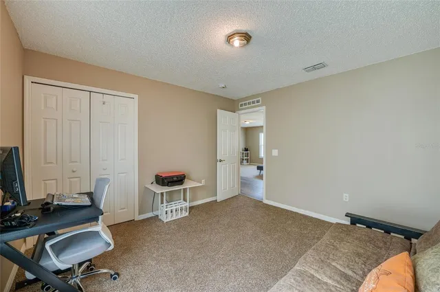 a bedroom with a workspace