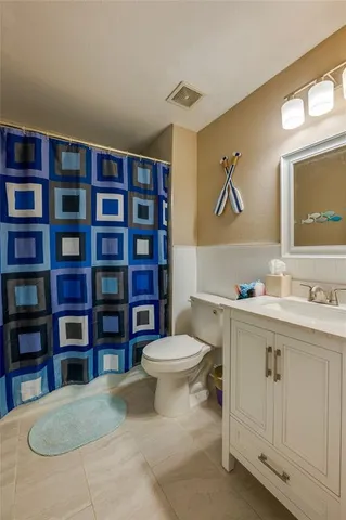 a bathroom with a toilet sink and shower