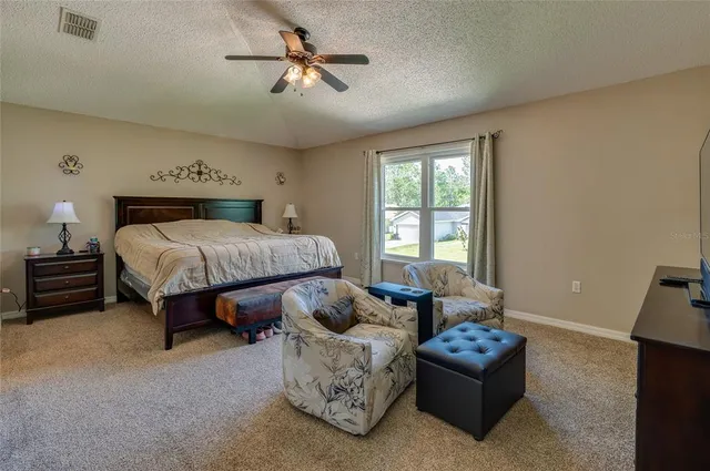 a spacious bedroom with a bed and a couch