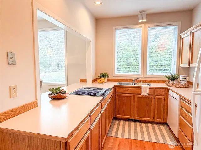 a white bath tub sitting next to a white sink and vanity