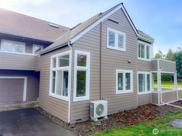a dining room with furniture a chandelier and wooden floor