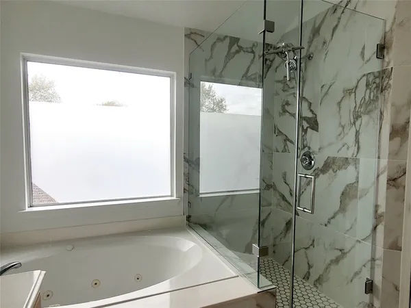 a bathroom with a bathtub and shower