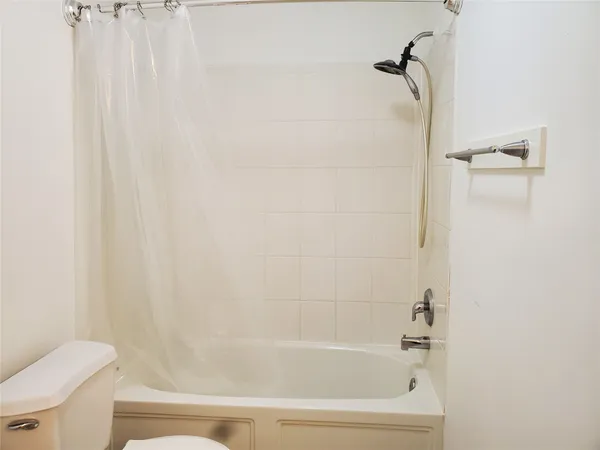 a bathroom with a bathtub and a toilet