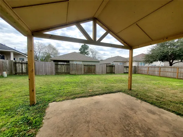 a view of a house with a yard and tree s