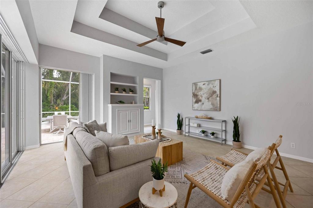 8204 Waterview Boulevard Lakewood Ranch, FL 34202 - Photo 19 of 77 a living room with furniture a flat screen tv and a large window