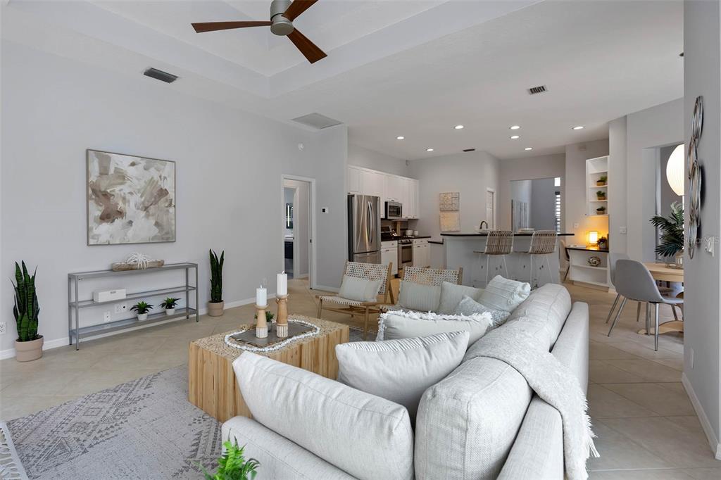 8204 Waterview Boulevard Lakewood Ranch, FL 34202 - Photo 20 of 77 a living room with furniture and a dining table with kitchen view