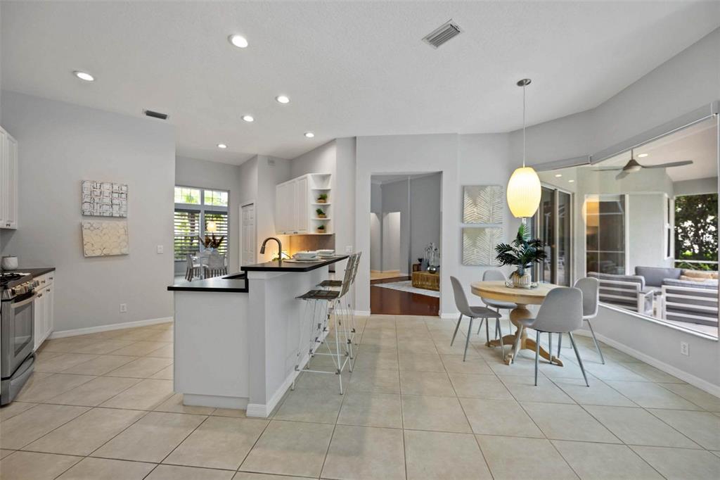 8204 Waterview Boulevard Lakewood Ranch, FL 34202 - Photo 21 of 77 a kitchen with stainless steel appliances kitchen island granite countertop a sink and cabinets