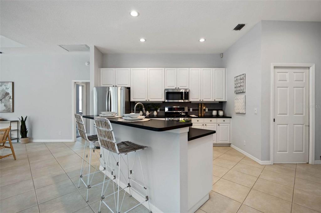 8204 Waterview Boulevard Lakewood Ranch, FL 34202 - Photo 23 of 77 a kitchen with stainless steel appliances a refrigerator and a stove top oven